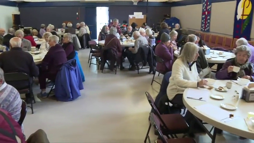 Volunteers at St. Andrew's Church in Sidney dish up nourishment for the body and the soul